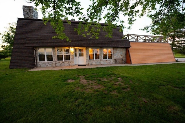 back of house with a patio area and a lawn