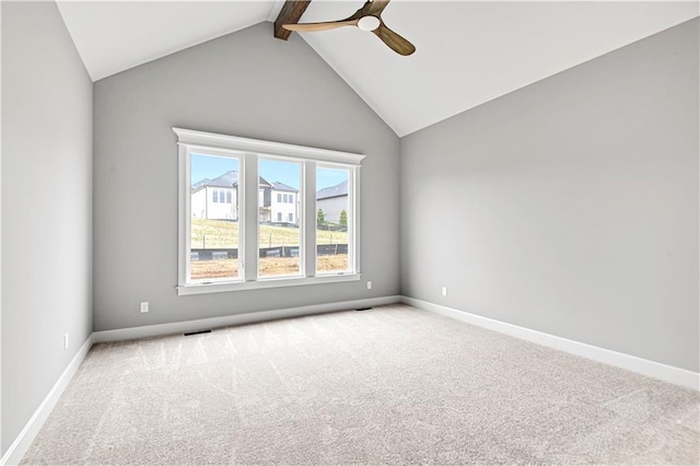 spare room featuring ceiling fan, light colored carpet, and lofted ceiling with beams