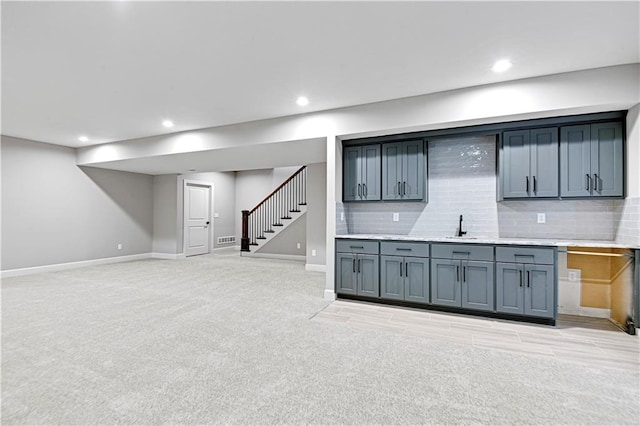 interior space featuring wet bar and light carpet