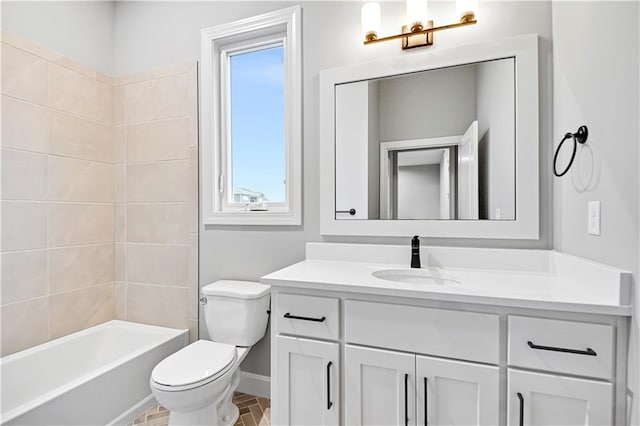 full bathroom featuring vanity, tiled shower / bath combo, and toilet