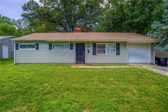 single story home featuring a garage and a front lawn