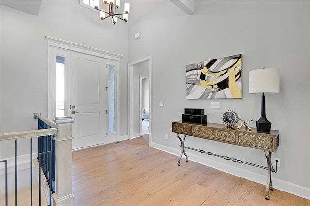 entrance foyer with hardwood / wood-style flooring and a notable chandelier