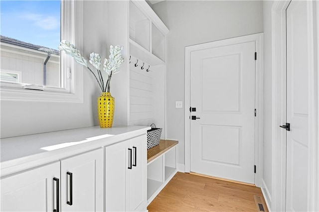 mudroom with light hardwood / wood-style floors