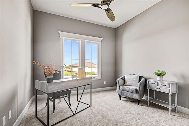 carpeted home office with ceiling fan