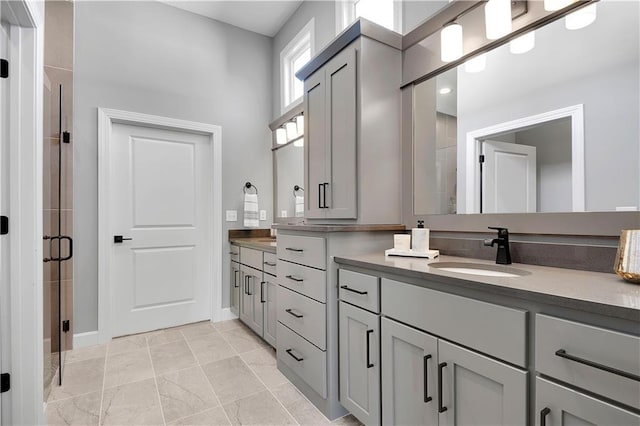 bathroom with vanity and a shower with shower door