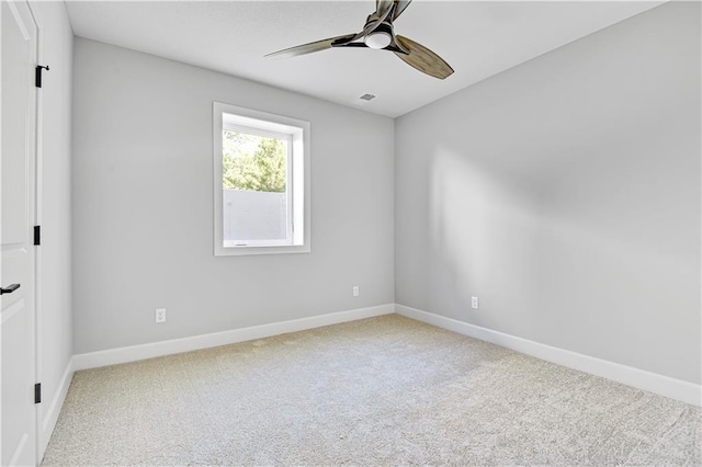 carpeted empty room featuring ceiling fan