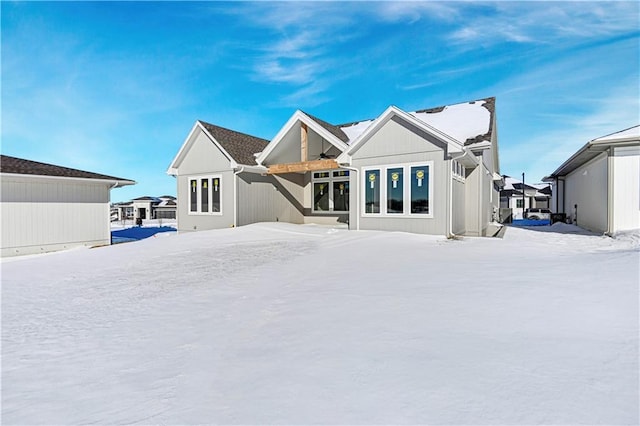 view of snow covered back of property