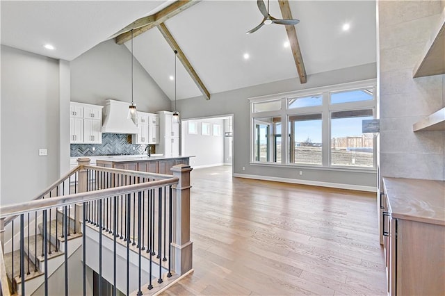22047 W 94th St, Lenexa, KS 66220 - kitchen with custom exhaust hood, beam ceiling, a ceiling fan, high vaulted ceiling, and decorative backsplash