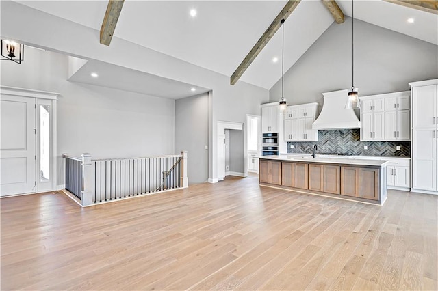 22047 W 94th St, Lenexa, KS 66220 - kitchen featuring custom exhaust hood, beamed ceiling, high vaulted ceiling, light countertops, and decorative backsplash