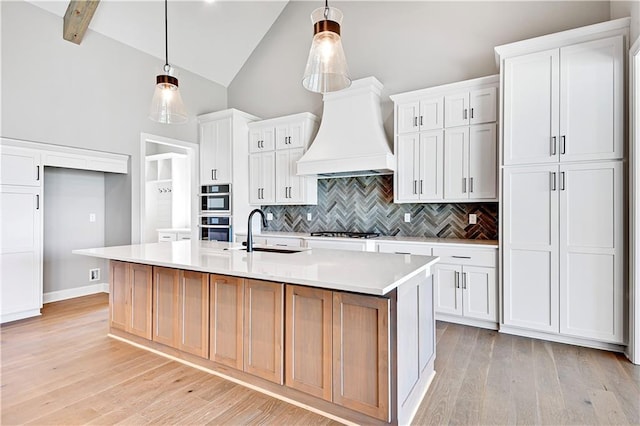 22047 W 94th St, Lenexa, KS 66220 - kitchen featuring custom range hood, tasteful backsplash, light wood-style floors, light countertops, and high vaulted ceiling