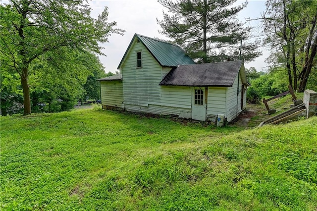 view of property exterior with a yard