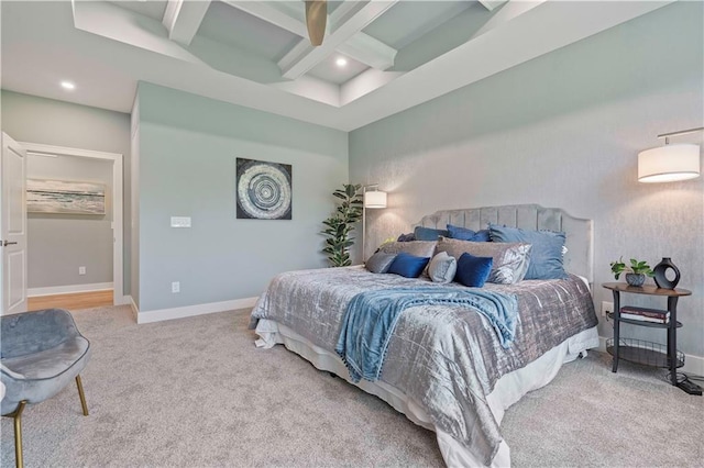 carpeted bedroom with coffered ceiling and beamed ceiling