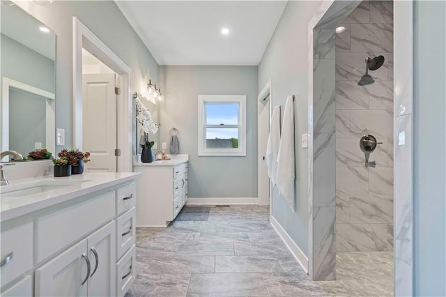 bathroom featuring vanity and a tile shower