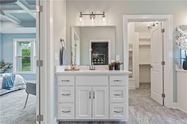 bathroom with beam ceiling, vanity, and coffered ceiling