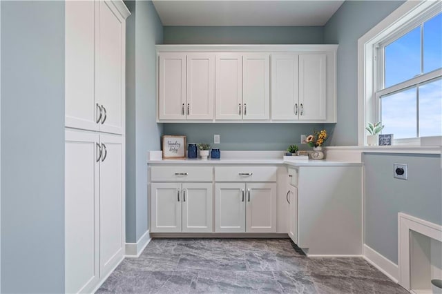 laundry area featuring electric dryer hookup and cabinets