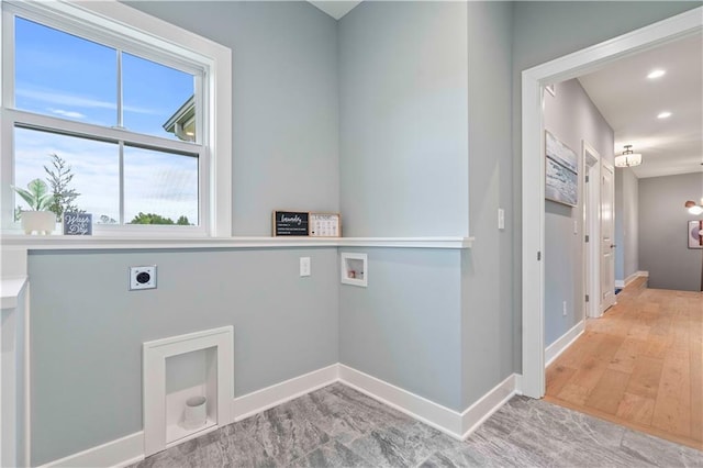 laundry room with hookup for a washing machine, hardwood / wood-style floors, and electric dryer hookup