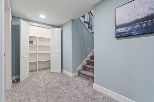 basement featuring light carpet