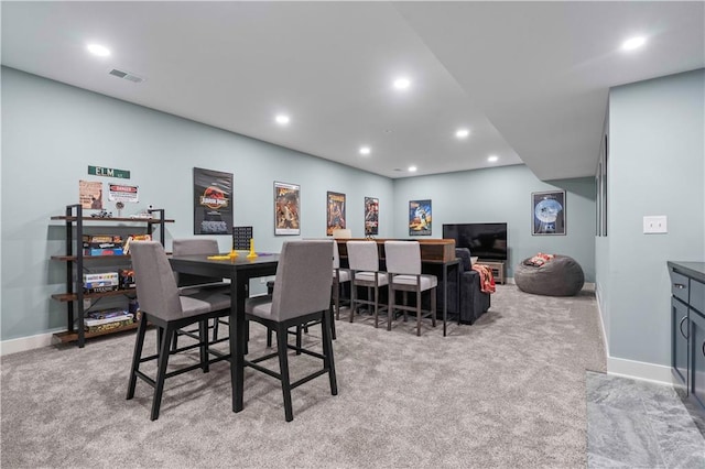 dining area featuring light carpet