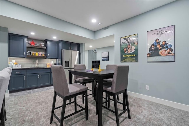 carpeted dining space featuring indoor wet bar