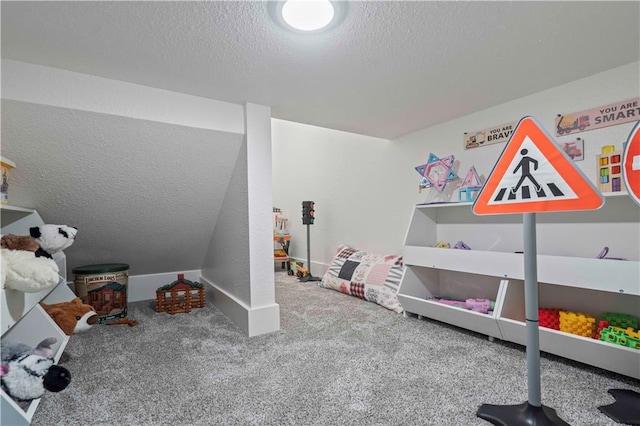 recreation room with carpet flooring and a textured ceiling