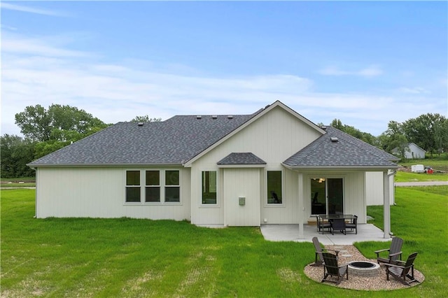 rear view of property with a patio area, a lawn, and a fire pit