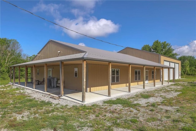 rear view of property with a patio area and central AC