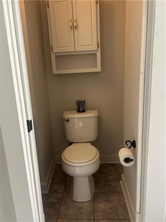 bathroom with tile patterned flooring and toilet