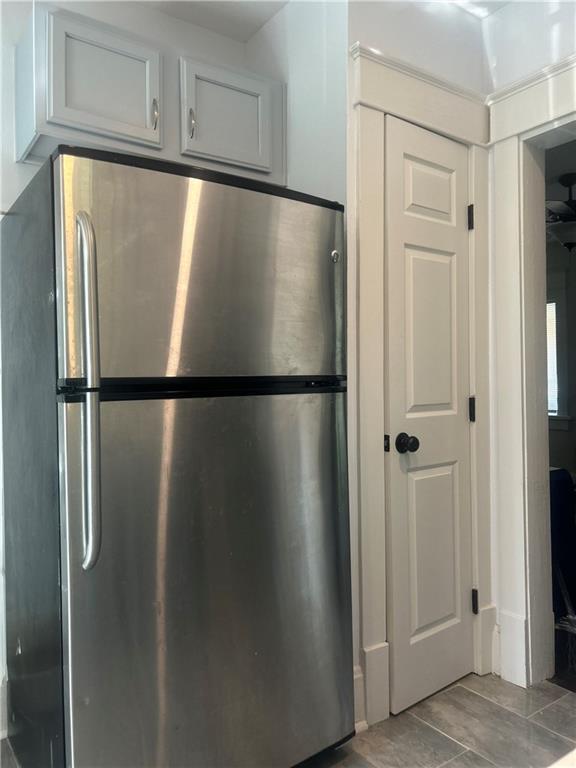 kitchen with white cabinets and stainless steel fridge