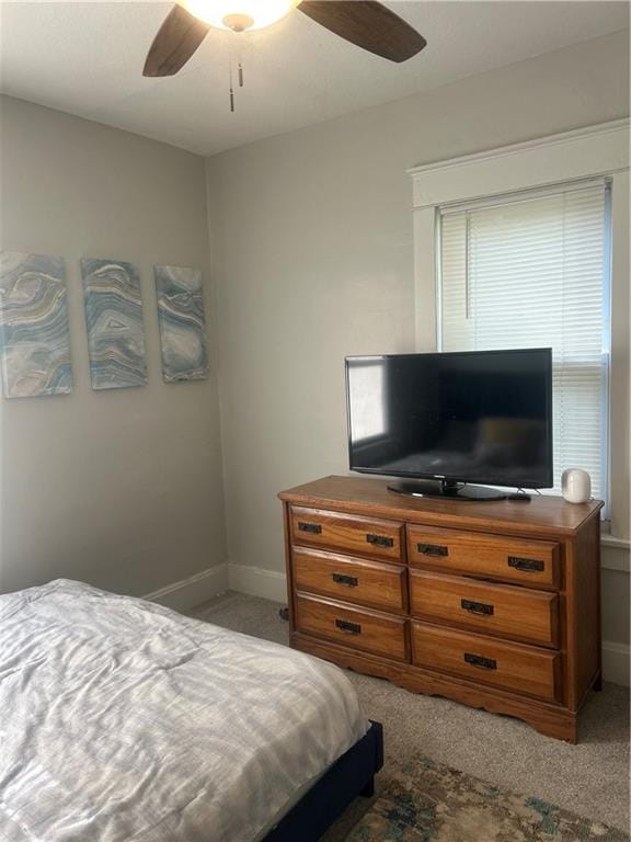 bedroom featuring ceiling fan and light carpet