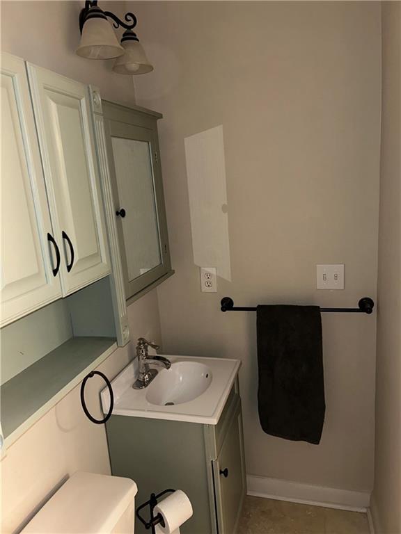 bathroom featuring tile patterned floors, vanity, and toilet