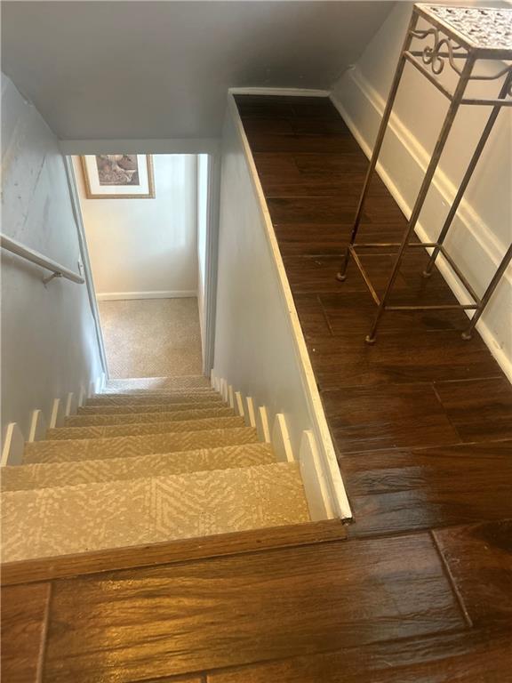 stairway featuring hardwood / wood-style floors