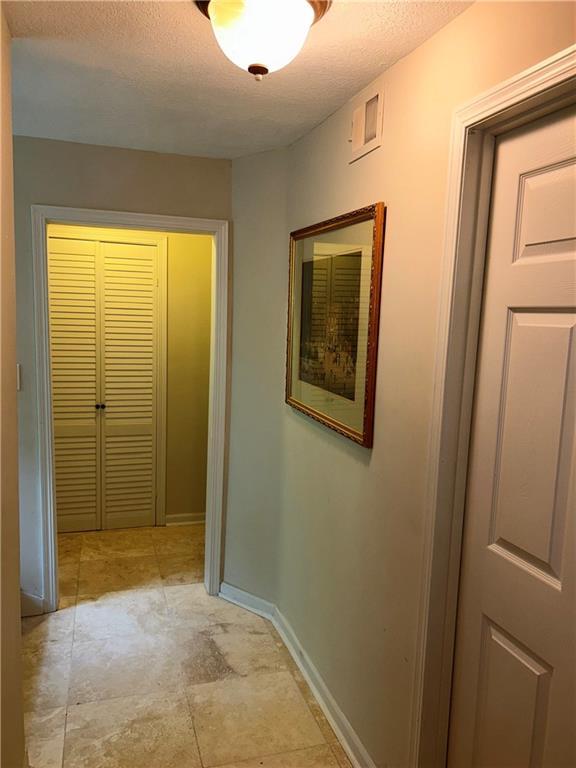 hallway with a textured ceiling