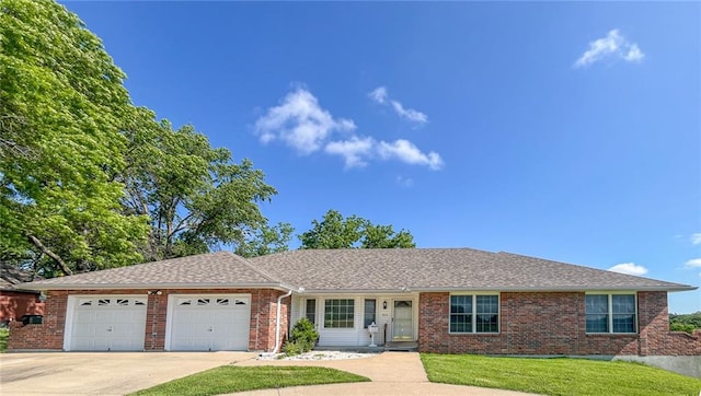 single story home with a garage and a front lawn