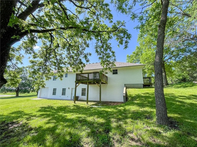 rear view of property with a lawn and a wooden deck