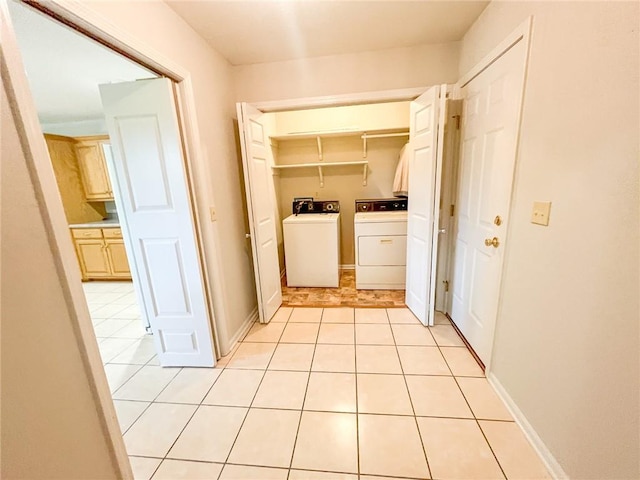 washroom featuring independent washer and dryer, hookup for a washing machine, and light tile floors