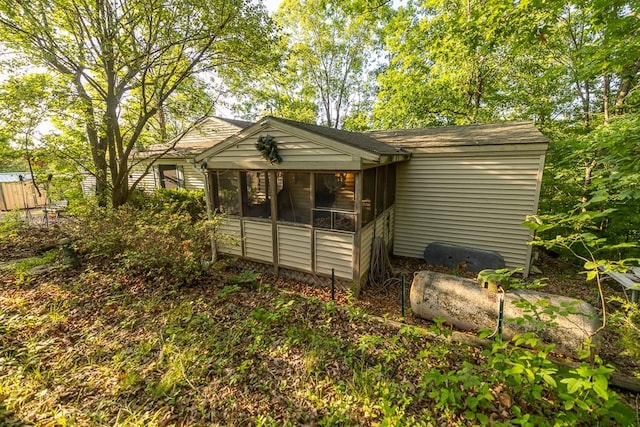 view of outdoor structure featuring a sunroom