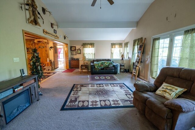 carpeted living room with ceiling fan and vaulted ceiling