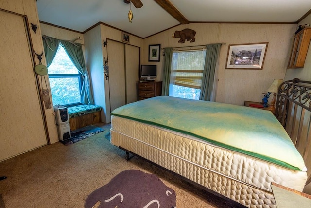 carpeted bedroom featuring vaulted ceiling with beams, a closet, and ceiling fan