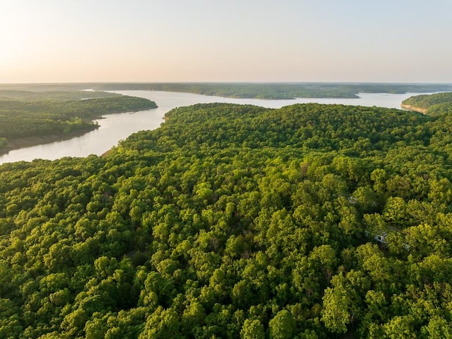 aerial view at dusk featuring a water view