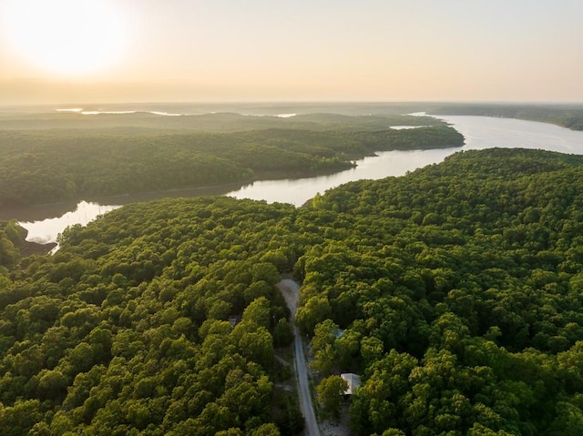 aerial view at dusk featuring a water view