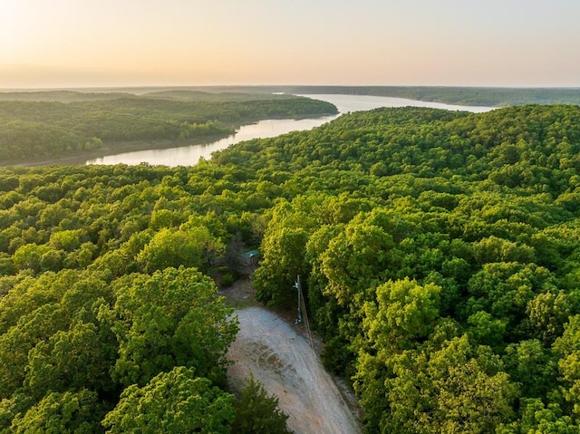 aerial view at dusk featuring a water view