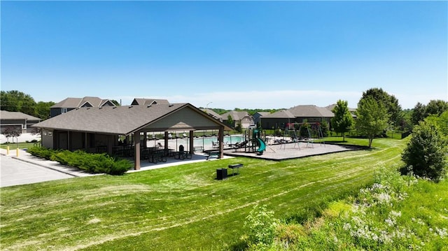 view of home's community with a playground and a yard