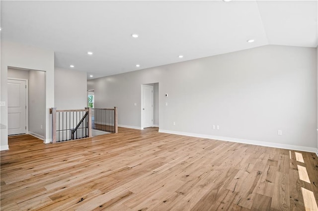 unfurnished room featuring light hardwood / wood-style floors and vaulted ceiling