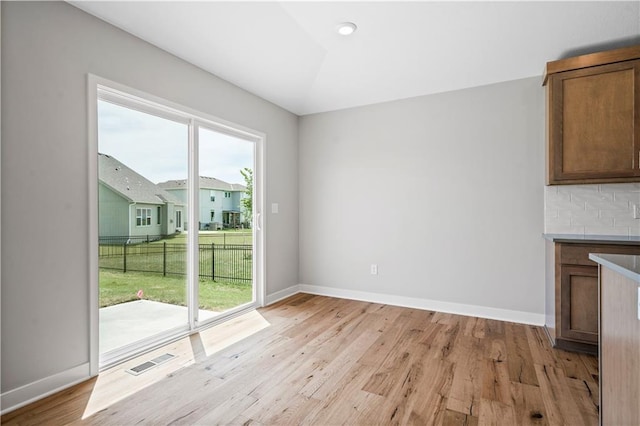 unfurnished dining area with light hardwood / wood-style floors