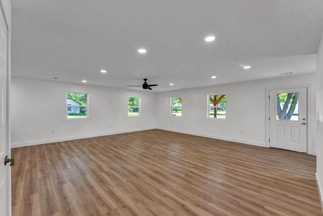 unfurnished room with ceiling fan and light hardwood / wood-style floors