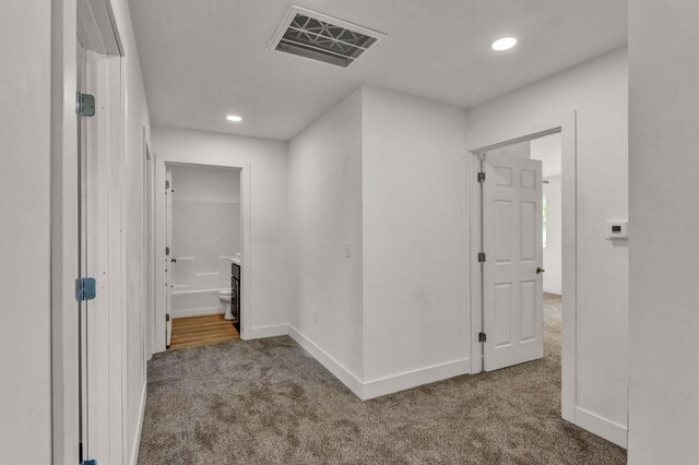 hallway featuring carpet flooring