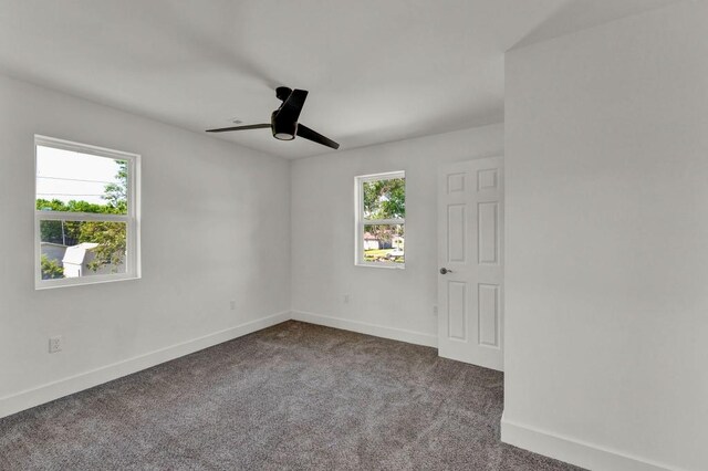 carpeted spare room featuring ceiling fan