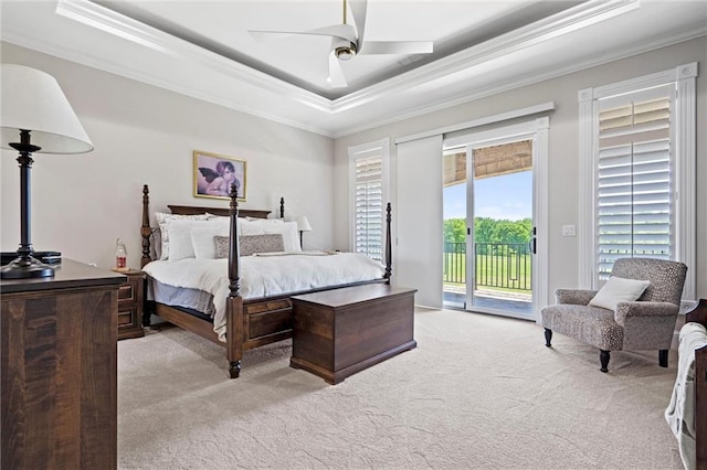 bedroom featuring light carpet, access to outside, ceiling fan, and a tray ceiling