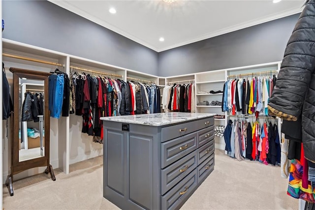 walk in closet featuring light colored carpet