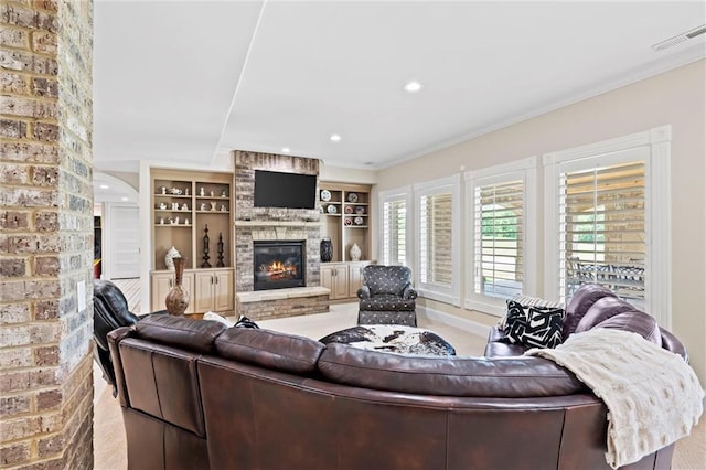 carpeted living room with built in shelves, a fireplace, and ornamental molding